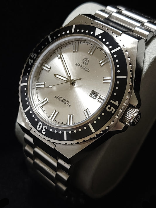 Silver with White dialon Black bezel